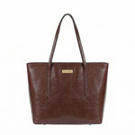 A dark brown faux-leather tote bag with dual shoulder straps and a small gold-tone 'CAVERO' brand plaque on the front, shown against a plain white background.