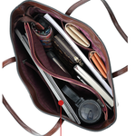 Open brown leather bag with various items including a laptop, phone, and wallet.