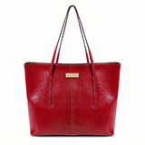 A red faux-leather tote bag with dual shoulder straps and a small gold-tone metal brand plaque on the front, shown against a plain white background.