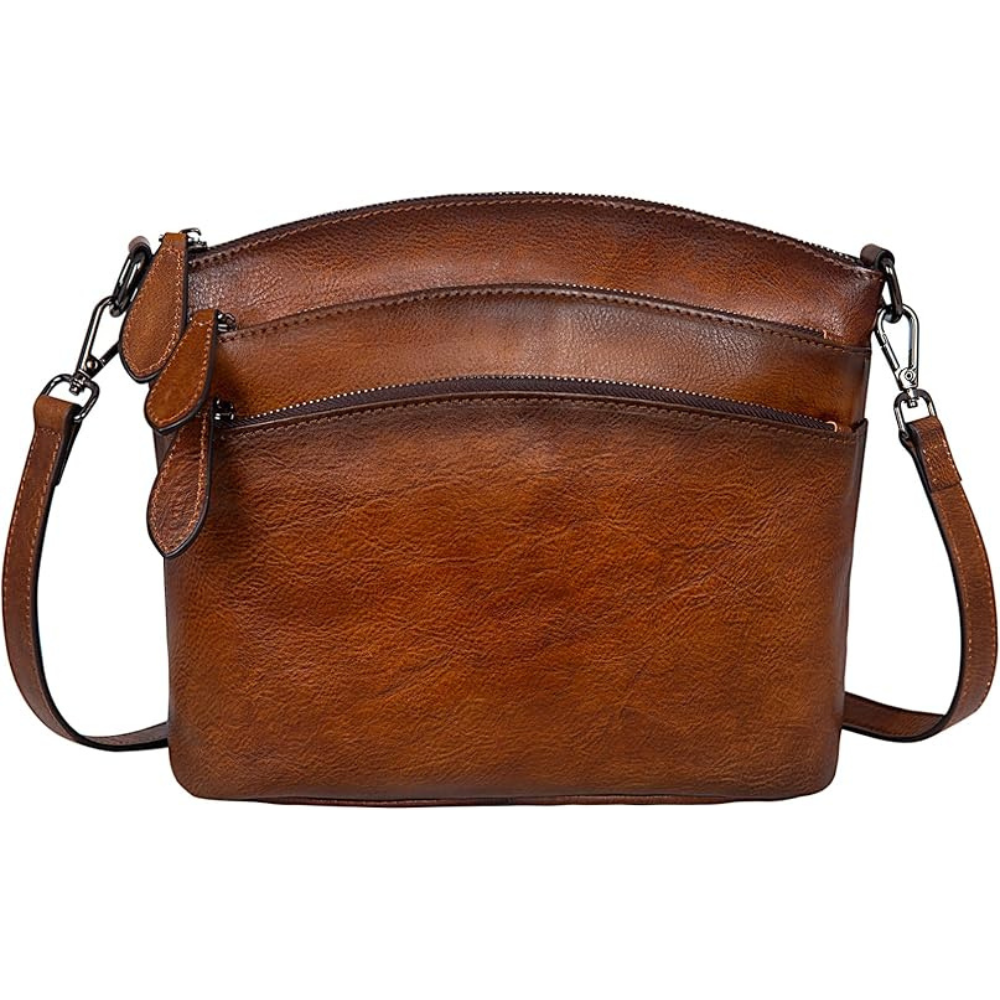 Brown leather handbag with a strap on a white background