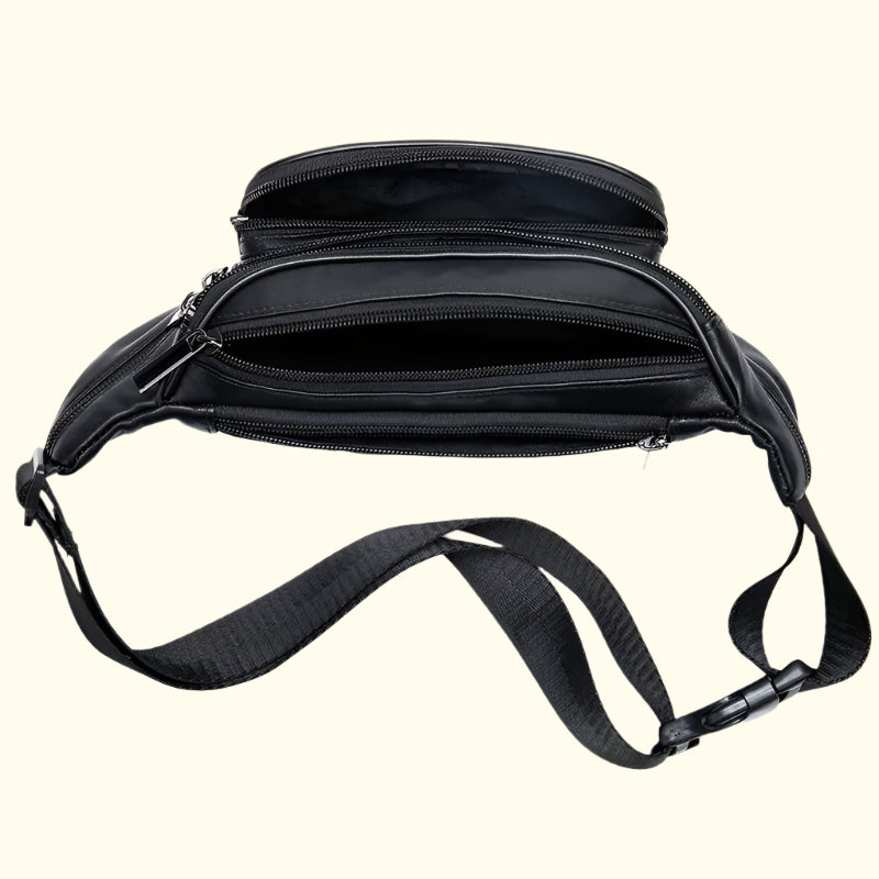Black waist bag with multiple zippers on a beige background