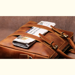 Brown leather briefcase with newspapers on a brown background