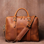 Brown leather briefcase with a strap on a brown background