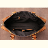 Brown leather bag with open top on a brown background