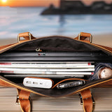 Open leather briefcase with laptop and documents against a blurred outdoor background